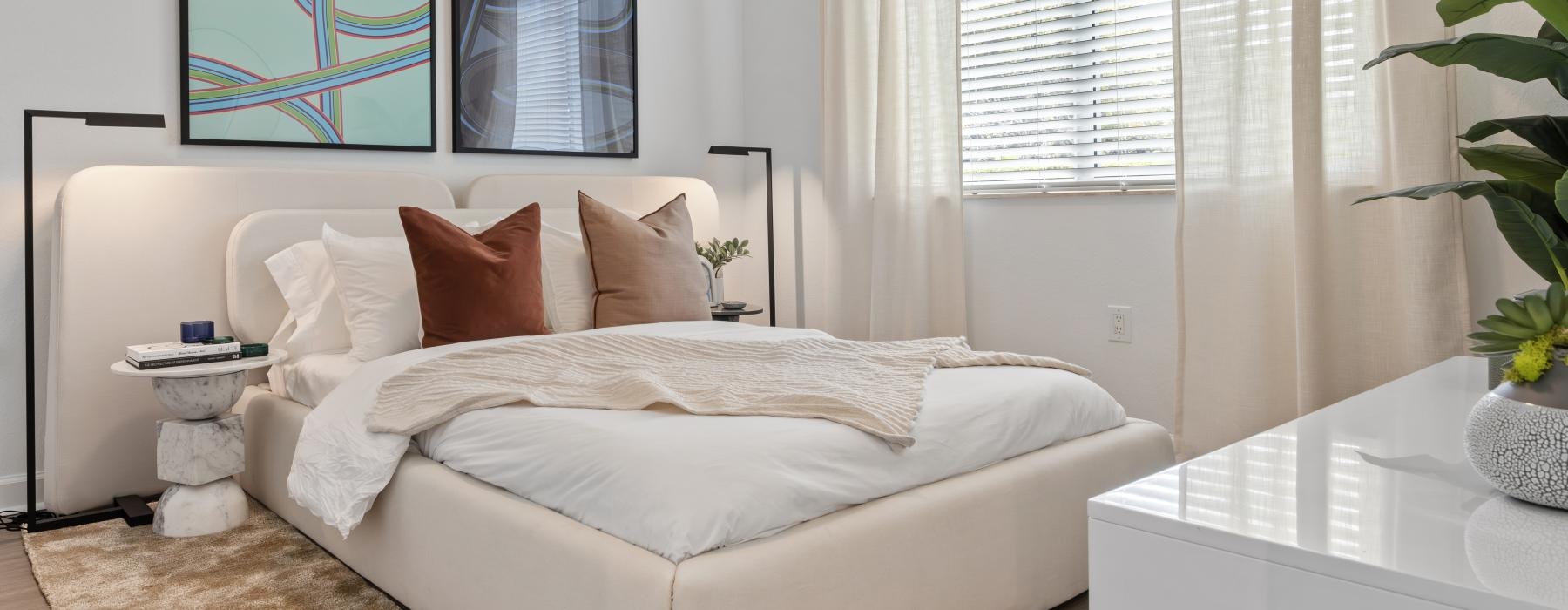 a bed in a room with natural lighting