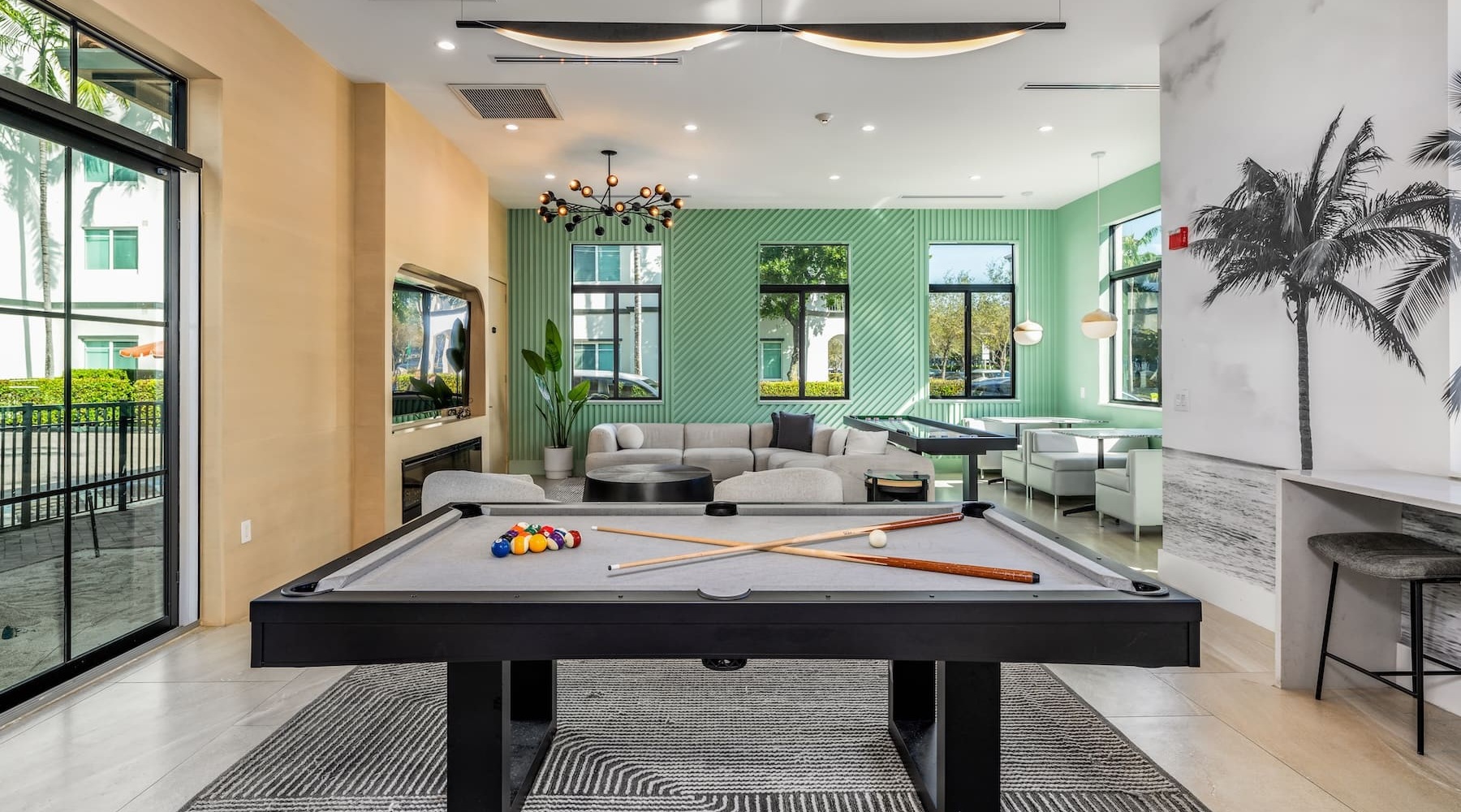 All the comforts of luxury living pool table in a bright room with seating
