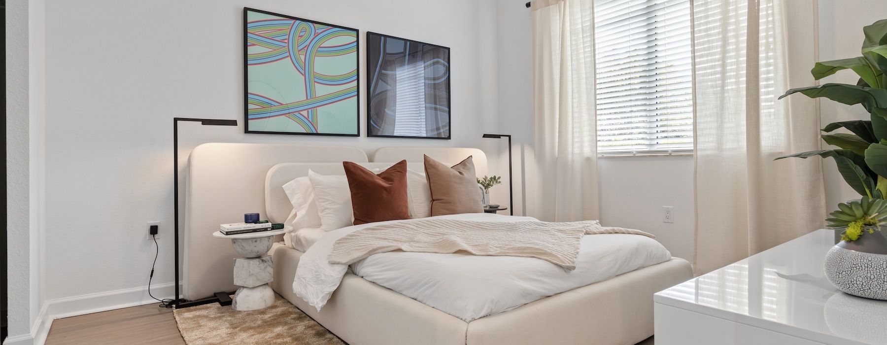 a bedroom with a bed and two lamps