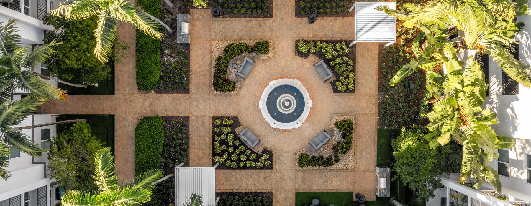 an aerial view of courtyard with palm trees